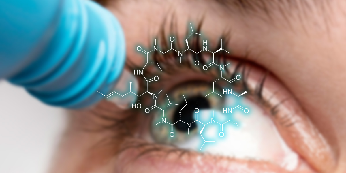 occhio in primo piano con un flacone di collirio con formula di ciclosporina al centro dell'immagine